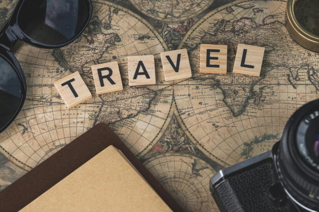 automotive Vintage map with travel essentials like camera and sunglasses arranged in a flat lay, perfect for adventure themes.